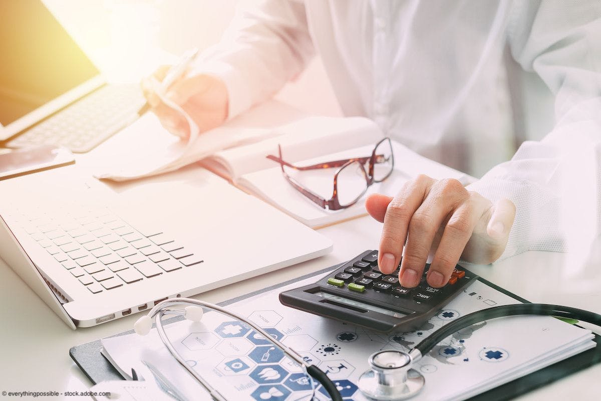 Doctor using calculator | Image Credit: everythingpossible - stock.adobe.com