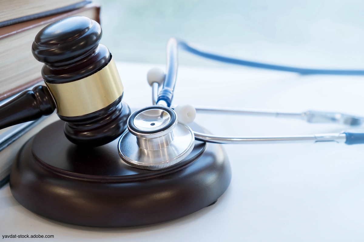 gavel and stethoscope lying on table